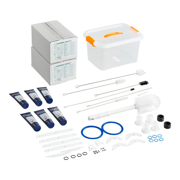 A maintenance kit for the Spaceman 6236-C soft serve ice cream machine, including cleaning brushes, gaskets, lubricants, replacement parts, and a storage container.