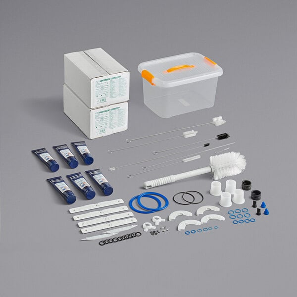A Spaceman soft serve machine maintenance kit in a plastic container with a yellow handle.