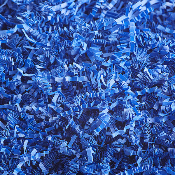 A pile of Spring-Fill Royal Blue Crinkle Cut paper shred.