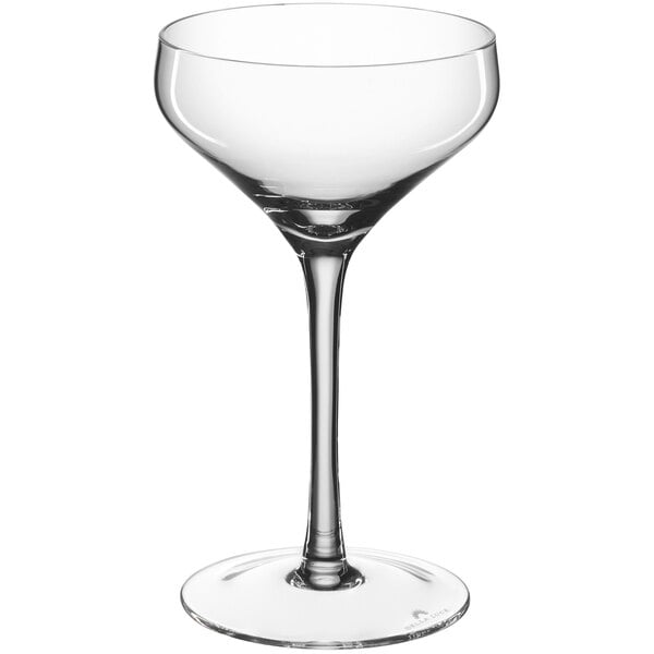 A clear coupe glass with a long stem on a white background.
