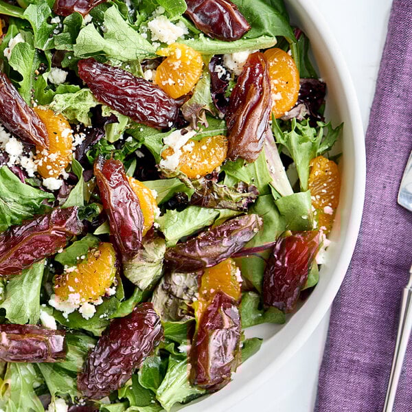 A salad with dried fruits and cheese, including Fancy Dried Medjool Dates.