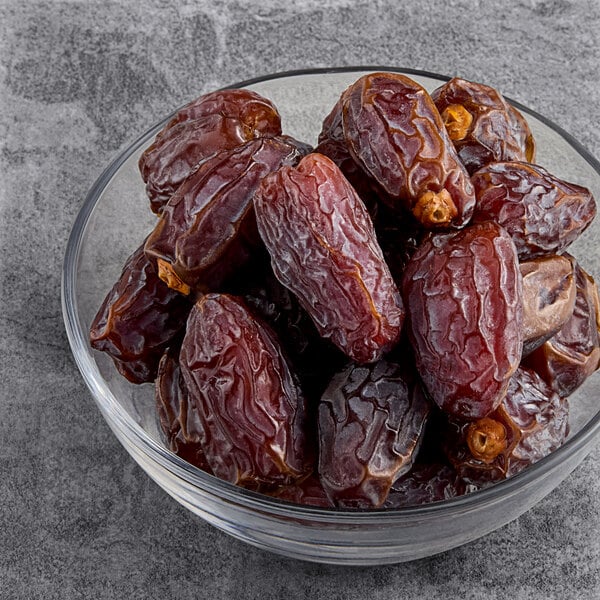 A bowl of Fancy Dried Medjool Dates on a table.