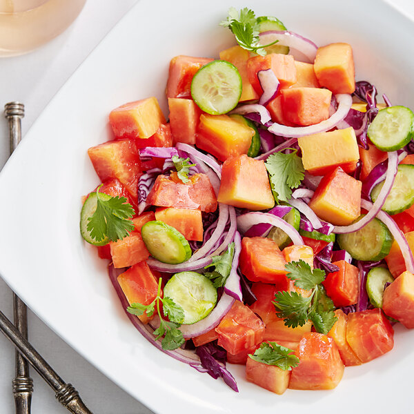 A close up of a bowl of Fresh Tainung-Type Papaya cubes.
