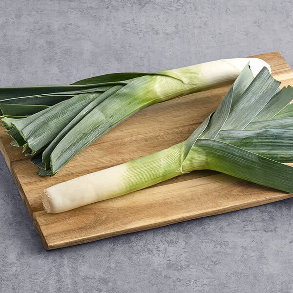 Two leeks on a cutting board.