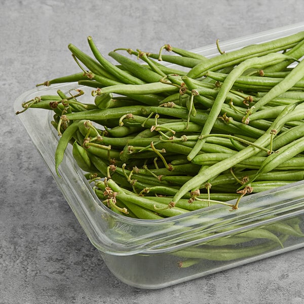 A container of fresh French beans.