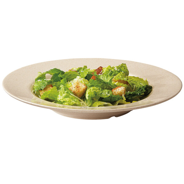 A bamboo melamine bowl filled with salad and croutons.