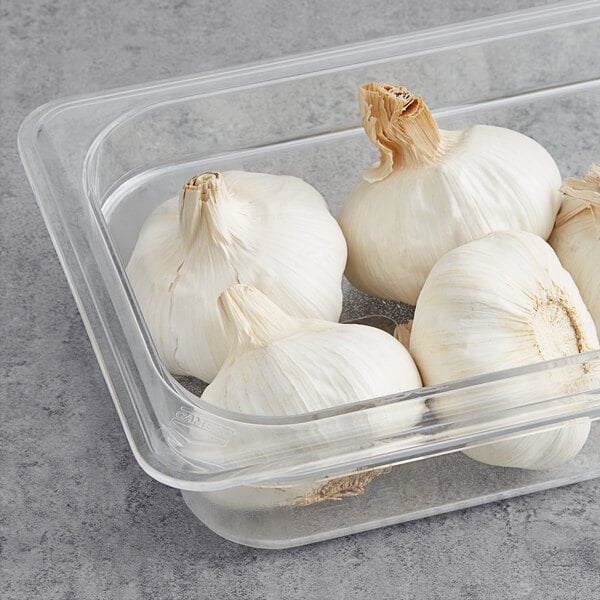 White garlic cloves in a clear container