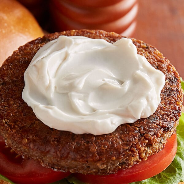 A burger with Follow Your Heart Vegenaise on top.