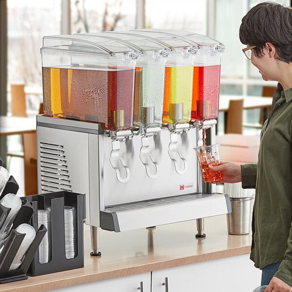 A man pouring liquid into a Crathco beverage dispenser.