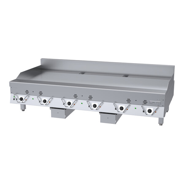 A large stainless steel commercial griddle with multiple control knobs and a flat cooking surface.