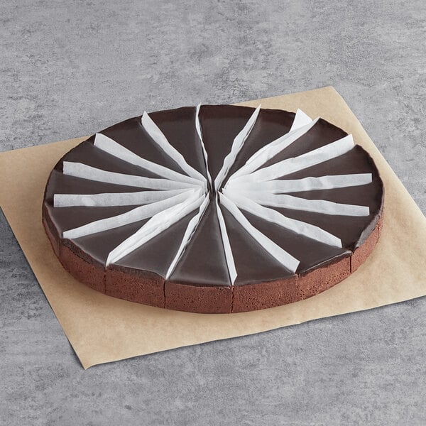 A Sweet Street Desserts flourless chocolate torte with white paper strips on top.