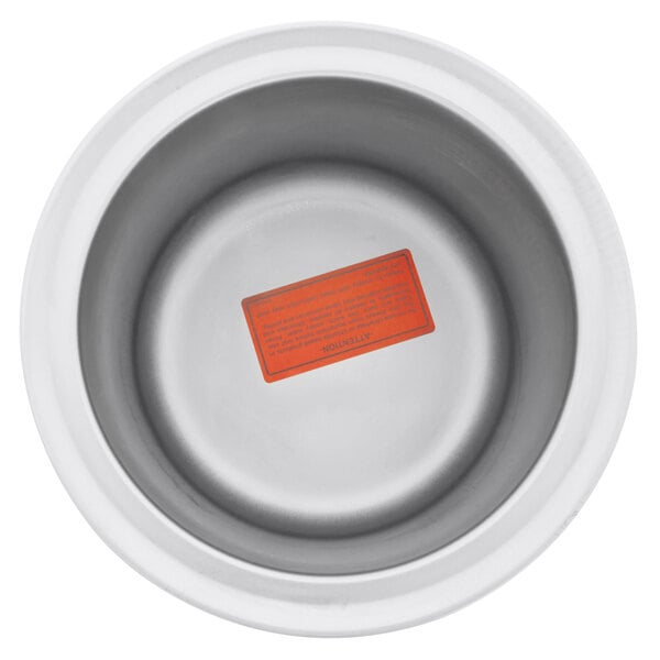 A white container with a red label inside a white round warmer.