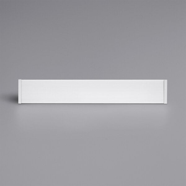 A white rectangular object with black lines on a gray background.