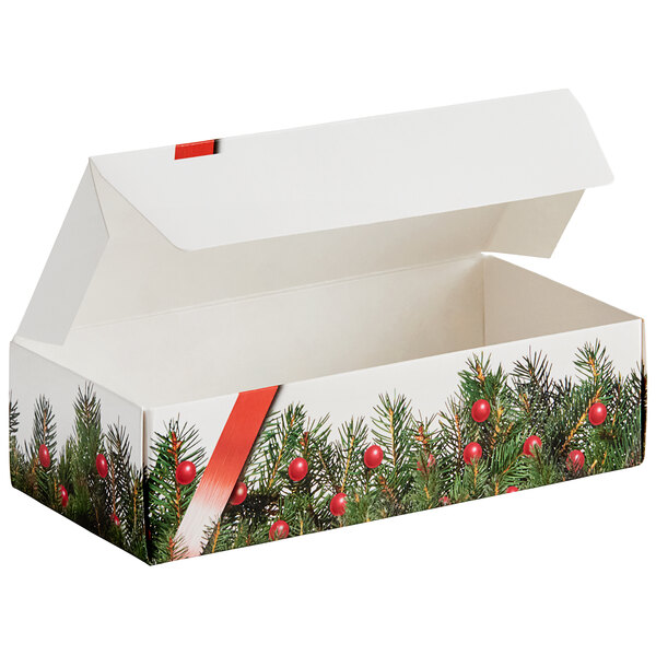 A white candy box with a red and green tree and berry print.
