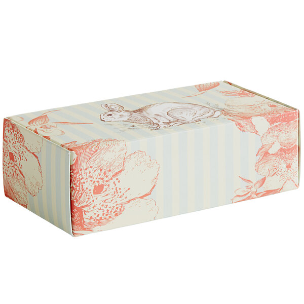 A white candy box with a vintage rabbit print on it.