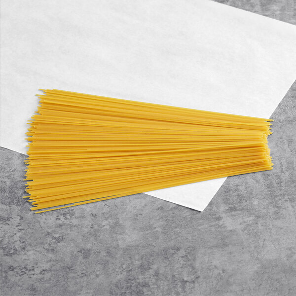 A bunch of Barilla Protein+ spaghetti on a white paper.
