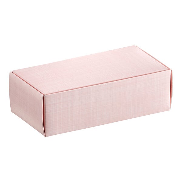 A close-up of a pink 1/2 lb. linen candy box.
