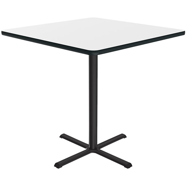 A Correll white square bar height table with a black metal base.