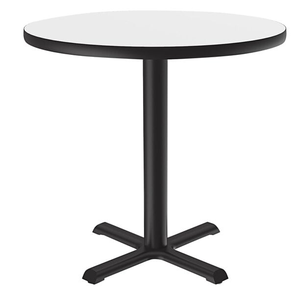 A Correll round table with a white high-pressure dry erase board top and black base.