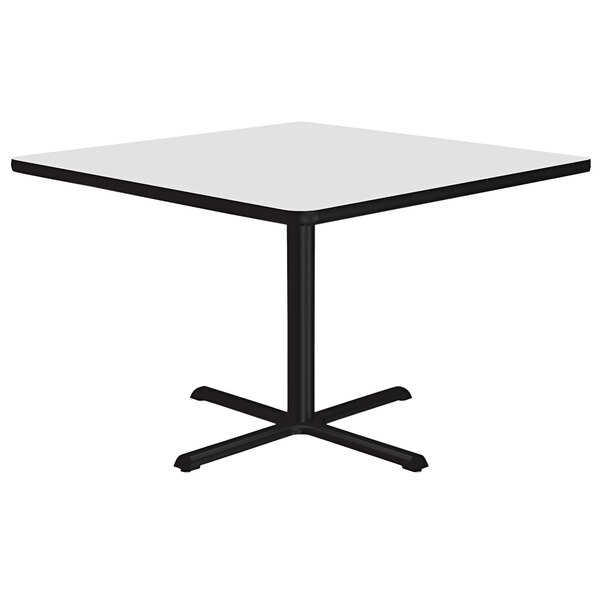 A white square table with black base.