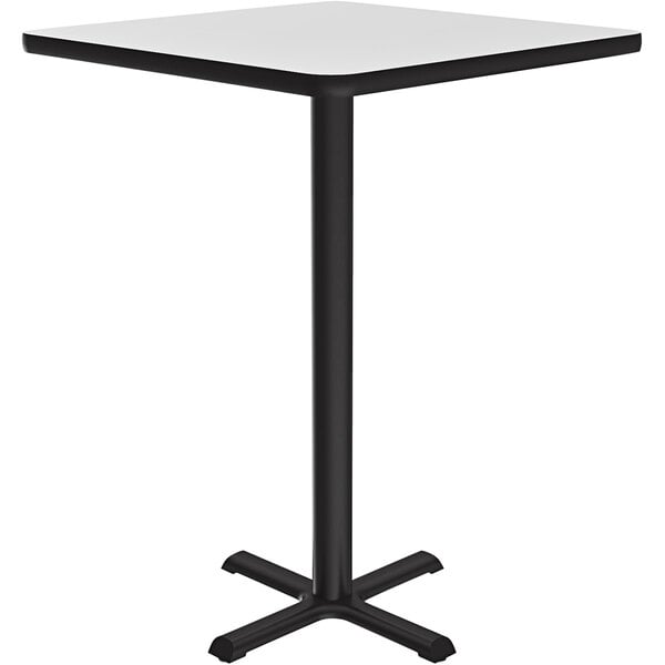 A Correll white square bar height table with a black base.