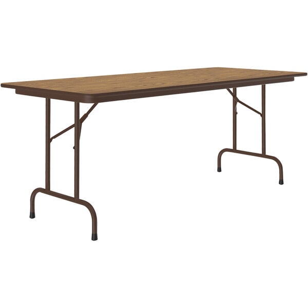 A medium oak rectangular Correll folding table with a brown metal frame.