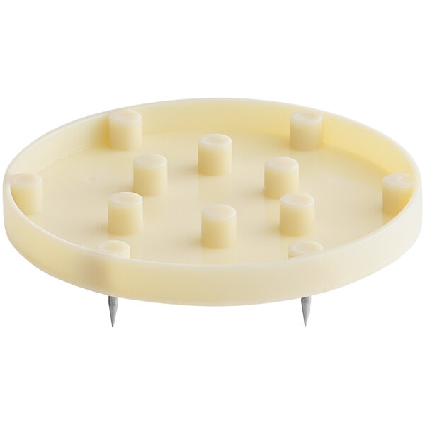 A white circular plate with nail claws on it.