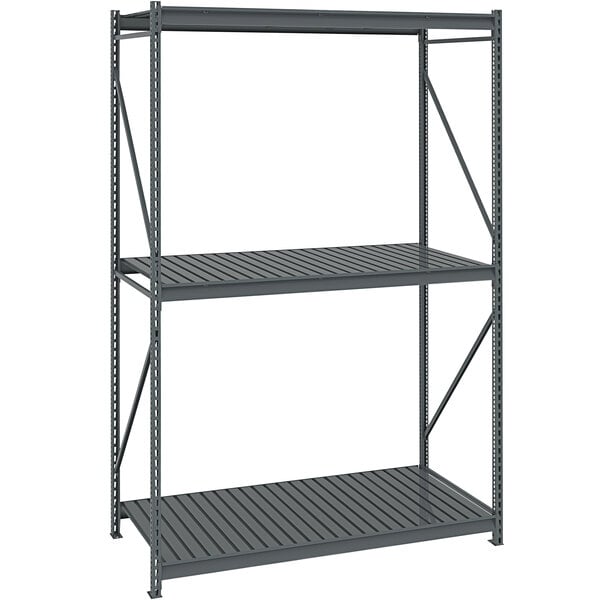 A dark gray metal Tennsco bulk storage rack unit with corrugated decking.
