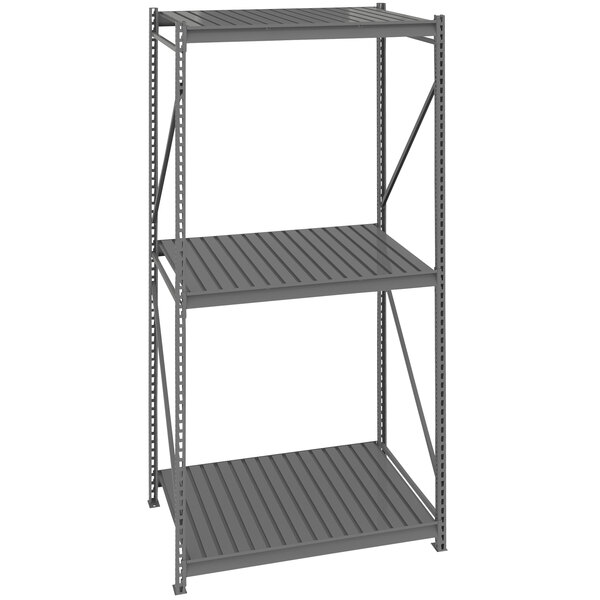 A dark gray metal Tennsco bulk shelving unit with corrugated shelves.