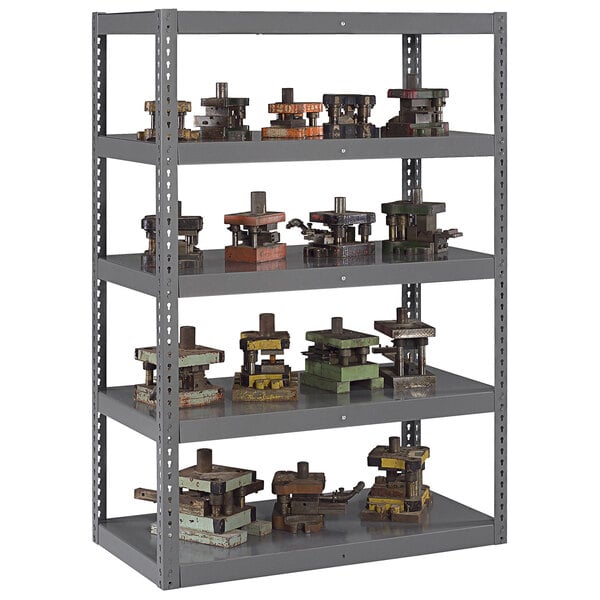 A Tennsco dark gray steel boltless shelving unit with shelves holding metal objects.