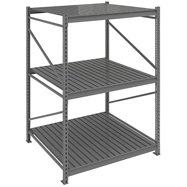 A dark gray metal Tennsco bulk shelving unit with corrugated decking on three shelves.
