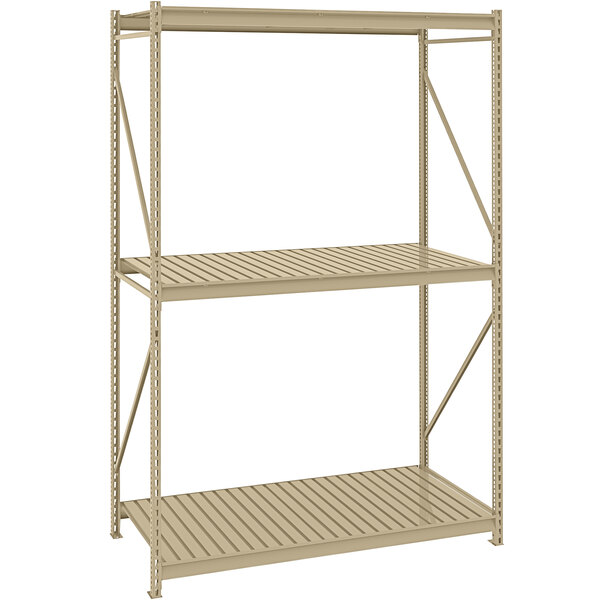 A tan metal Tennsco bulk storage rack with corrugated shelves.