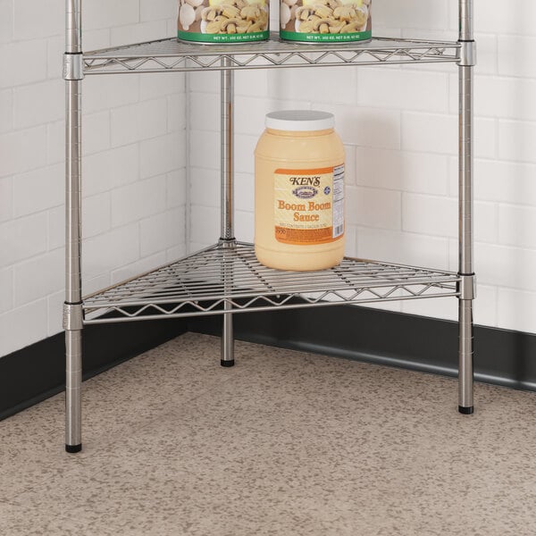 A Regency chrome triangle shelf with jars of food on it.