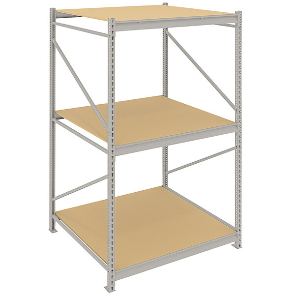 A metal Tennsco boltless shelving unit with two shelves and tan particleboard decking.