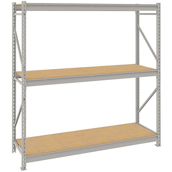 A Tennsco light gray metal bulk shelving unit with 3 shelves with particleboard decking.