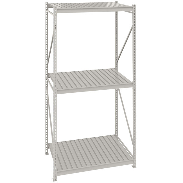 A light gray Tennsco bulk storage rack unit with corrugated metal shelves.