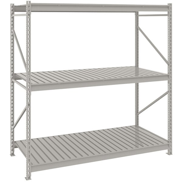 A light gray metal Tennsco boltless shelving unit with corrugated decking.