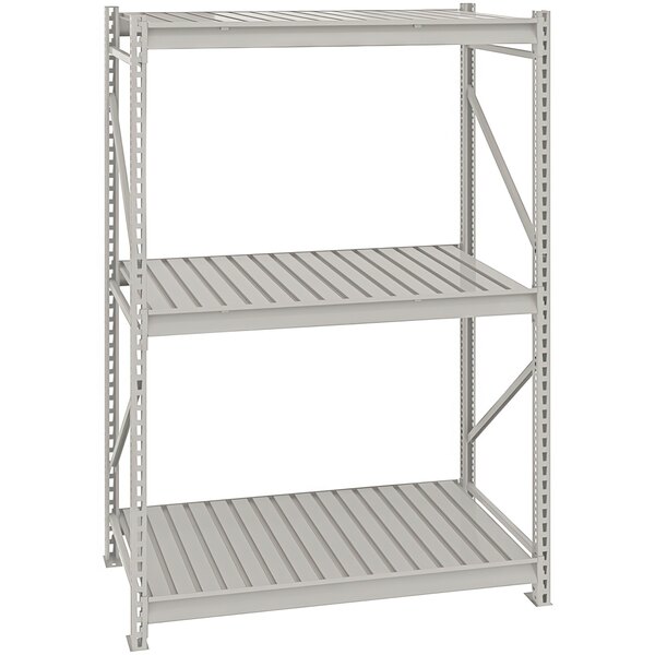 A light gray steel Tennsco bulk storage rack unit with corrugated decking.