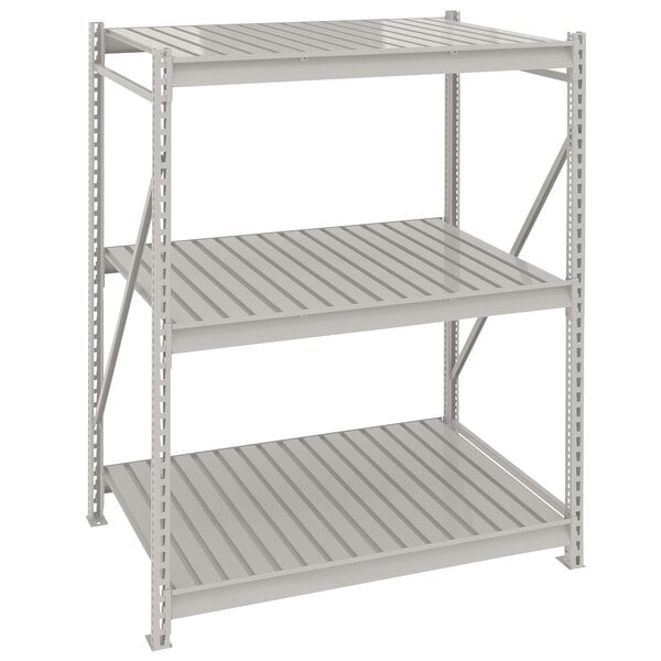 A light gray metal Tennsco boltless shelving unit with corrugated decking.