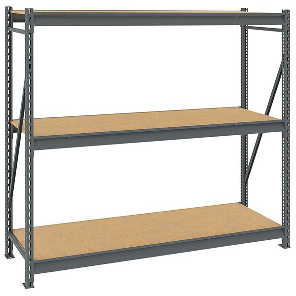 A Tennsco dark gray metal bulk storage rack with particleboard shelves.