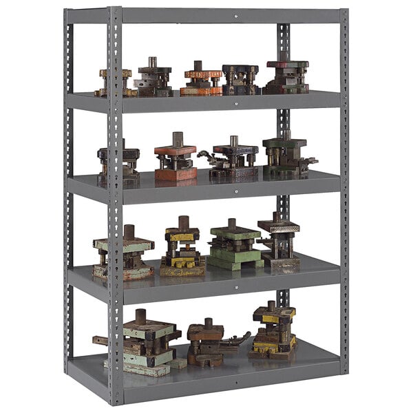 A dark gray Tennsco die rack shelving unit with metal objects on the shelves.
