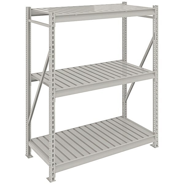 A light gray metal Tennsco boltless shelving unit with corrugated metal decking.