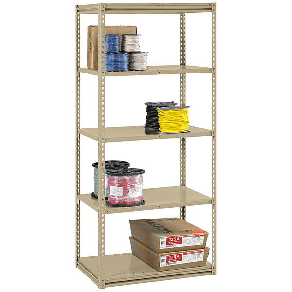 A beige Tennsco boltless steel shelving unit with shelves holding brown boxes.