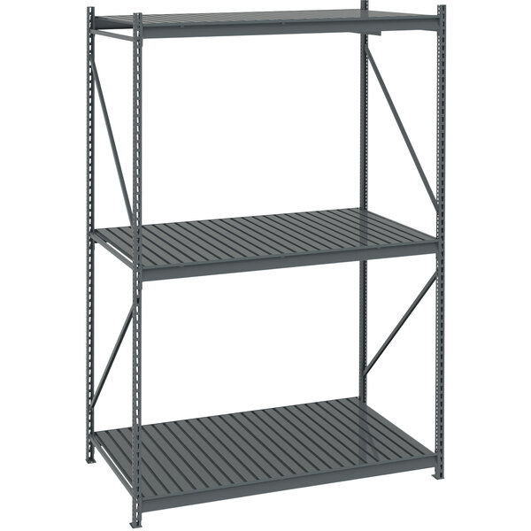 A grey metal Tennsco bulk storage rack unit with corrugated decking.