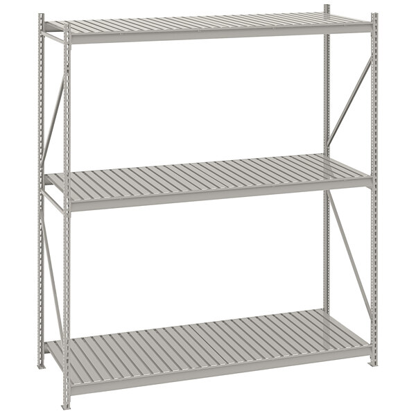 A light grey Tennsco boltless shelving unit with three tiers of corrugated decking.