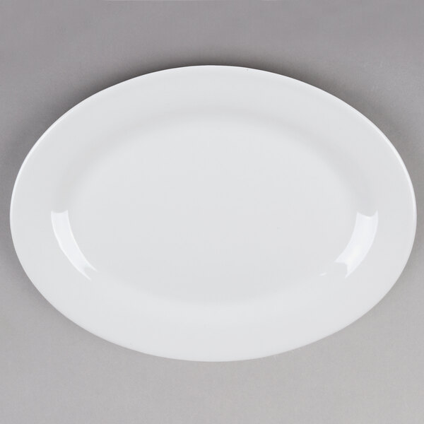 A Tuxton Alaska white china platter with a wide rim.