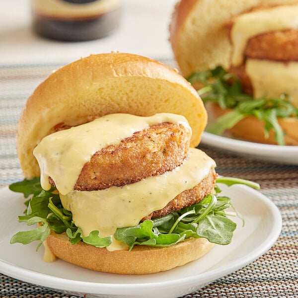 Two burgers with garlic parmesan sauce on a white background.