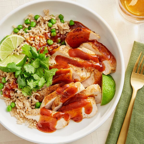 A bowl of Caribbean jerk chicken and rice with vegetables.