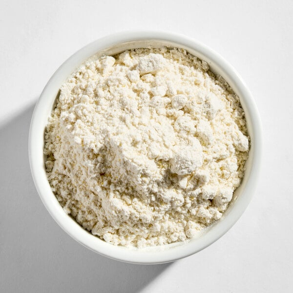 A white bowl filled with Golden Dipt Belgian Waffle Base Mix powder.