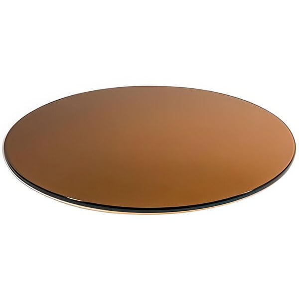 A round brown surface with a black edge on a table.